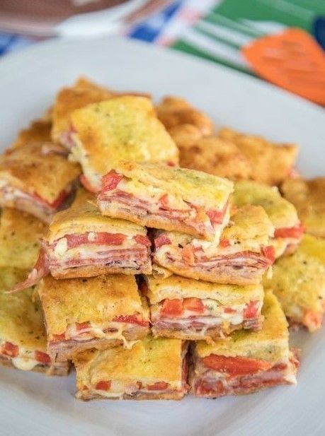 Antipasto Squares recipe – SO GOOD!! Crescent rolls stuffed with ham, salami, pepperoni, provolone, swiss, and roasted red peppers. then topped with a parmesan cheese, egg and pesto mixture and baked. These things are ridiculously good!!! There are never any leftovers when I take these to party!     Yield: 24 INGREDIENTS: 2 (8-oz) cans ... Read more Antipasto Squares, Apple Bites Recipe, Antipasto Tray, Antipasto Appetizer, Football Friday, Antipasto Pasta Salads, Italian Antipasto, Chicken Dip Recipe, Buffalo Chicken Dip Recipe