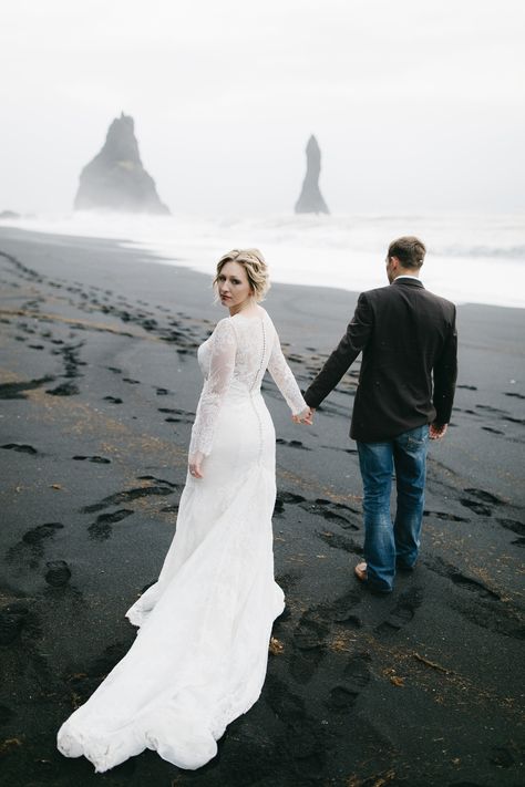 A beautiful bride walks with her groom on a black sand beach in Vik, looking over her shoulder at Iceland Wedding Photographers Colby and Jess, colbyandjess.com Travel Elopement, Southern Iceland, Photo Moodboard, Iceland Elopement, Iceland Adventures, Iceland Wedding, Elopement Ceremony, Black Sand Beach, Elopement Locations