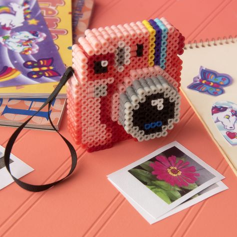 Keep the memories of your first instant camera
alive with this cute 3-D replica. Prop your finished design on a desk or shelf. Hama Beads Design 3d, Harmer Beads, Fuse Beads 3d, 3d Camera, Slime Crunchy, Easter Egg Ornaments, Random Crafts, Easy Perler Beads Ideas, 3d Perler Bead