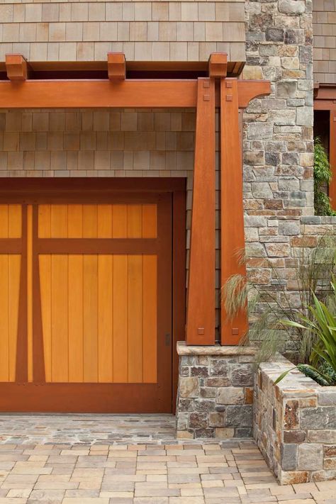 A transformed California Craftsman house features garage doors framed by a shallow pergola with tapering columns and exposed tenons. Garage Door Modern, Garage Door Framing, Craftsman Columns, Modern Craftsman Home, Door Pergola, California Craftsman, Craftsman Garage, Building A Porch, Craftsman Exterior