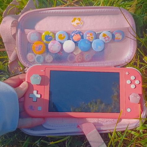 Cute Nintendo Switch Lite Accessories, Coral Nintendo Switch Lite Aesthetic, Nintendo Lite Accessories, Switch Astethic, Holding Nintendo Switch Reference, Nintendo Switch Aesthetic Kawaii, Aesthetic Nintendo Switch Lite, Nintendo Switch Aesthetic Case, Switch Lite Aesthetic