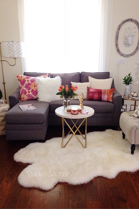 In this room the pop of bright color from 2 pillows is accentuated by the grey and white colors surrounding them. White is a bright color too. In this case it is positioned on every surface in this room. The white coffee table (from HomeGoods) helps visually in making this vignette feel complete and anchors the space. Sponsored by HomeGoods Furnitur Ruang Keluarga, First Apartment Decorating, Decor Ikea, Small Apartment Living Room, Small Living Room Decor, Room Apartment, Small Apartment Decorating, Small Apartment Living, Apartment Decor Inspiration