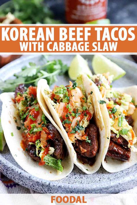 Korean beef tacos with kimchi and cabbage slaw are the perfect option to spice up your taco night. The meat is marinated in a flavorful mixture that makes the protein extra tender and juicy. Wrapped in a tortilla with your choice of toppings, it can't be beat. Get the recipe now. #easyweeknightmeal #taconight #foodal Ground Beef Tacos With Cabbage Slaw, Korean Tacos Ground Beef, Korean Steak Tacos, Slow Cooker Korean Beef Tacos, Korean Beef Tacos With Kimchi, Korean Beef Tacos, Korean Tacos, Beef Wraps, Beef Tacos Recipes