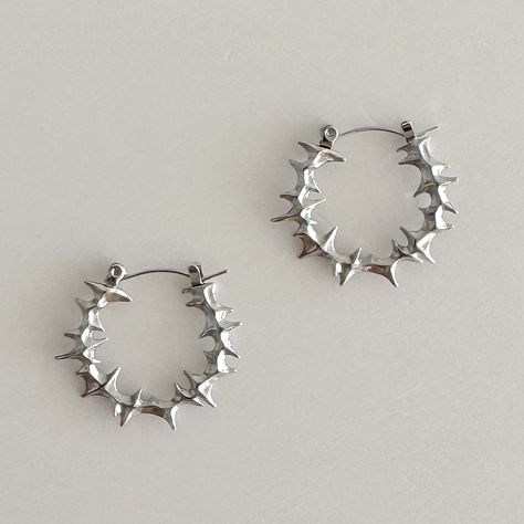 Elevate your style with these bold, spiky stainless steel hoop earrings. 100% stainless steel, 1" diameter. The modern design features small spikes that add an edgy statement to any look. Made from durable stainless steel, these earrings are lightweight and comfortable for all-day wear. Add a touch of contemporary attitude to your ensemble with these standout hoops. We ship in 1-3 days, all purchases come with complimentary jewelry pouch and box. Grunge Hoop Earrings, Silver Alt Jewellery, Silver Cartilage Earrings, Silver Clay Jewellery Ideas, Cool Silver Earrings, Classy Silver Jewelry, Cute Jewelry Silver, Cool Earrings Unique, Spiky Earrings