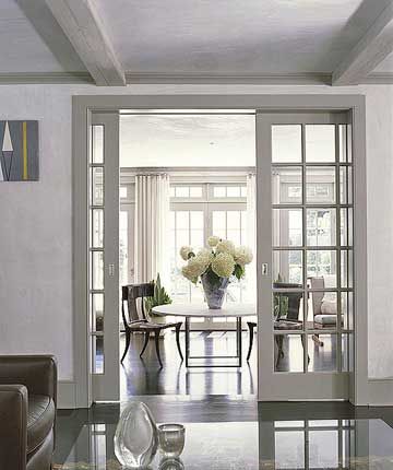 Paned-glass Pocket Doors  What's more convenient than doors that disappear when you don't need them? That's the beauty of pocket doors. These paned-glass interior doors mimic the home's exterior windows. Leading from the living room, the pocket doors open on to an airy sunroom with casual dining and sitting space. Sliding Doors Dining Room, Kitchen Living Room Divider Sliding Doors, Grey French Doors Interior, Lounge To Dining Room Doors, Sliding Glass Doors Dining Room, Internal Sliding Doors Room Dividers, Pocket Doors With Glass Panels, Double Door Interior, Cavity Sliders