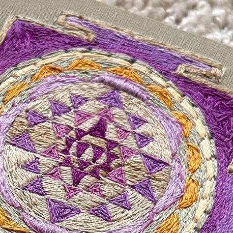 The Shri Yantra / Embroidery Art Piece Embroidery size 12x12 cm Thread Painting Art by Svitla *** What The Shri Yantra is? This sacred design, is a powerful tool used for meditation, concentration, and spiritual transformation. It facilitates a connection with divine power and strengthens the bond with celestial forces. ❤️ Add to Collection: https://www.etsy.com/listing/1723982892/the-shri-yantra-embroidery-art-piece #embroideryart #yantra #shriyantra #vedas #embroideryart #embroideryde... Chakra Embroidery Designs, Trish Burr Embroidery Thread Painting, Sri Yantra Mandala, Tripura Sundari Yantra, Semi-stitched Purple Resham Embroidered Fabric, Shri Yantra, Divine Power, Spiritual Transformation, Handmade Textiles