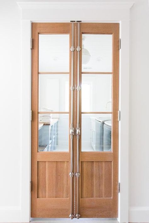 Past bi-fold cremone bolt doors a beautifully appointed gray and white laundry room features a window centered between a gray top loading washer and dryer and gray cabinets painted Sherwin Williams Silver Strand and topped with a wood countertop illuminated by a Hicks Pendant hung over a white hexagon tiled floor. French Pocket Doors, Tiny Powder Rooms, White Hexagon Tiles, Cremone Bolt, White Laundry Rooms, Laundry Room Doors, Pantry Makeover, Pantry Doors, Pantry Door