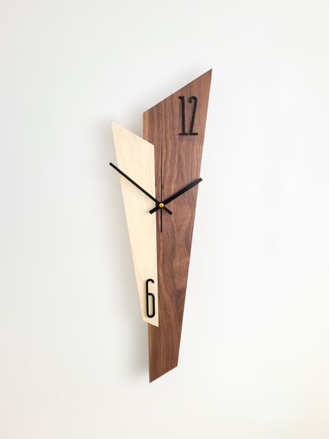 Sizes: 58x18x2cm This unique and special wall clock is not just a clock, but an elegant decoration for your home. Elevate your home décor with our elegant wall clock, crafted from premium walnut and white poplar. This minimalist masterpiece seamlessly blends into any style, adding a touch of sophistication and refined taste. This product is handmade in a small workshop in Hungary, where the master creates each piece with his own hands with love and careful attention. This is how time, nature and design will be in a unique harmony that lives on and tells without words all the experience-filled past that this tree has experienced. Clean and minimalist design: Our wall clock boasts a sleek and uncluttered aesthetic, perfectly complementing modern, contemporary, and Scandinavian interiors. Hig Diy Wood Clocks, Wood Clocks Handmade, Wooden Clock Ideas, Diy Clock Ideas, Wall Clock Design Modern, Modern Wall Clock Design, Mid Century Modern Clocks, White Poplar, Wood Clock Design