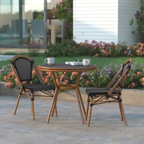 Bring the street vibes of Paris right into your restaurant, bistro, hotel, or backyard patio with this indoor/outdoor commercial grade bistro table. The durable PE Rattan structure and tempered glass top make for a reliable and stylish way to wow your guests while you serve customers or host friends and family. The lightweight, but durable, powder coated aluminum frame boasts a bamboo look finish, holds up to 200 lbs. static weight, and is rust-resistant. This table assembles easily in under ten Bistro Set Indoor, French Bistro Style, Patio Set Up, Bistro Patio Set, Bistro Design, Table And Two Chairs, French Bistro Chairs, Bistro Table Set, Street Vibes