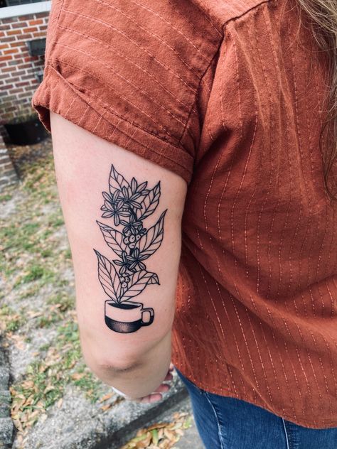 coffee plant and bean tattoo, flowing from a coffee cup Jacksonville, FL Flowers In Coffee Mug Tattoo, Neotraditional Coffee Tattoo, Coffee Cup With Flowers Tattoo, Coffee Bean Plant Tattoo, Planter Tattoo, French Press Tattoo, Gary Tattoo, Coffee Bean Tattoo, Flower Pot Tattoo