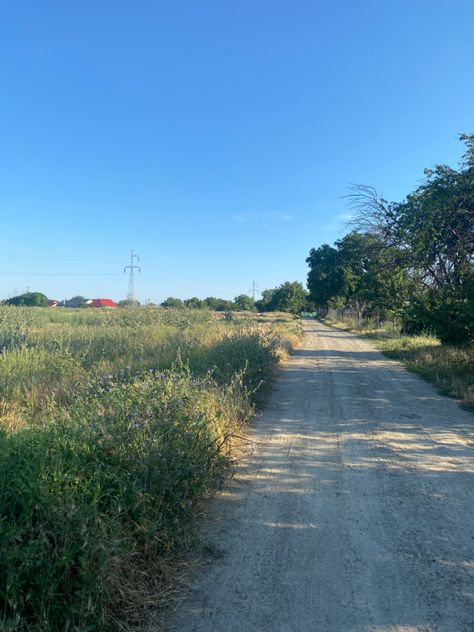 Image of a road in a small village area, surrounded by trees, bushes, flowers. The sky is clear and the sun is shining, suggesting a nice and warm temperature. Village Aesthetic, European Town, Mermaid Stories, European Summer Aesthetic, European Village, Europe Holidays, European Aesthetic, Europe Aesthetic, Small Town Life