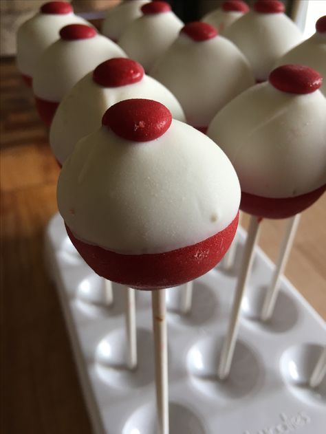 Fishing bobber cake pops! Bobber Cake Pops How To Make, Fish Gender Reveal Cake, Fishing Bobber Cake Pops, Fishing Bobber Cake, Bobber Cake Pops, Bobber Cake, Fishing Theme Birthday, Fishing Themed Birthday Party, Bday Themes