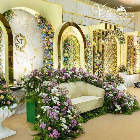 Create a regal seating arrangement for the bride and groom with a sofa decorated with exquisite flowers. Under the Gold Shimmer Theme, this floral arrangement adds a touch of natural beauty and elegance, perfectly blending with the luxurious golden decor, making the seating area a focal point of your wedding stage. Contact: 9894318883 | 6379033123 Email: vasavidecorations1955@gmail.com #vasavidecors #weddingdecors #coimbatorewedding #goldshimmertheme #wedding #specialday #decorators #weddin... Online Pic, Engagement Decor, Golden Decor, Engagement Decorations, Stage Decorations, Wedding Stage, Hindu Wedding, Coimbatore, Stage Design