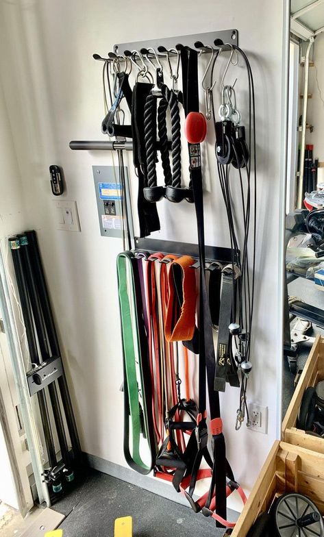 Keep your gym equipment organized and tidy with this sturdy storage rack. With multiple shelves and hooks, you can easily store your yoga mats, resistance bands, jump ropes, and more. #fitness #gym #homegym #workout https://www.theworldaccordingtome.org/fitness-health/1713761_at-home-gym-essentials-home-gym-on-a-budget/?home-gym-tour-with-andee-layne Tiny Home Gym, Home Gym On A Budget, Home Gym Storage, Gym Organizer, Home Gym Essentials, Dream Gym, Small Home Gym, Home Gym Garage, Mini Gym