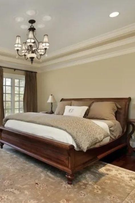 Traditional Primary Bedroom with Lamp Chandelier Suspended Over Wooden Sleigh Bed Traditional Primary Bedroom, Sleigh Bed Bedroom Ideas, Wooden Sleigh Bed, Back Room Ideas, Bed Bedroom Ideas, Light Gray Carpet, Primary Bedroom Ideas, Traditional Bedroom Design, Light Green Walls