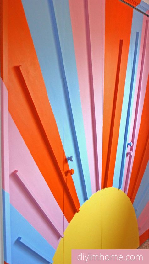 A step by step tutorial to make this vibrant and fun DIY closet door mural. Add sunshine and rainbow colors to your closet doors or a statement wall as DIY home decor! diy closet mural diy rainbow closet door Closet Murals Wall Art, Sunshine Mural, Indy Room, Closet Mural, Fun Accent Wall, Diy Closet Door, Bedroom Rainbow, Roll Up Garage Door, Rainbow Closet