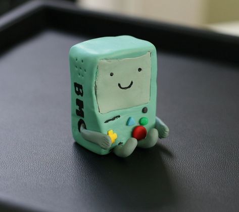 "Finn and Jake's best friend!  BMO sits about 1.5\" tall, and is a great companion for any work desk or bookshelf! This particular BMO was one of a kind- but due to popular demand, I will be starting to create more!         Please keep in mind all of my items are hand made to order and will not look exactly the same every time! I am but a human, not a robot.   Yet. ;)  AS OF OCTOBER 1st, 2021, THE USPS IS SLOWING DOWN SOME SERVICES Please understand I have nothing to do with the speed at which y Kids Pottery, I Have Nothing, October 1st, Frederick Md, Adventure Time Art, A Robot, Ceramics Projects, Cute Clay, Work Desk