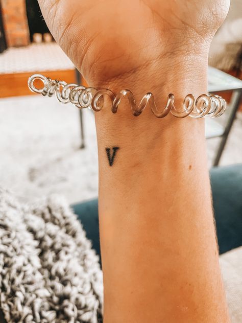 Small hidden tattoo for women. Roman number 5. Wrist tattoo Roman Numeral 5 Tattoo, Number 5 Tattoo Fonts, 5 Tattoo Ideas Number, Number 5 Tattoo Ideas, Number 5 Tattoo, Small Hidden Tattoos, V Tattoo, Secret Tattoo, Roman Tattoo