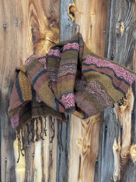 God, I love, love this wrap. These are wonderful colors! This is completely wool, but with different wools and playing with pattern. The pink and gold are woven in a "Honeysuckle Twill", which has been around for decades. This is my favorite style of weaving, which is going on my own whim. The edges are wavy, which is the way different fibers shrink in the fulling process. Wrap measures 20" X 70". Hand wash only. Hang dry. If you don't buy it, I will put it in my own closet. Earth Color, Lancaster Pa, On My Own, Shawls And Wraps, Custom Clothes, Pink And Gold, Scarf Accessory, Personalized Gifts, Etsy Accessories