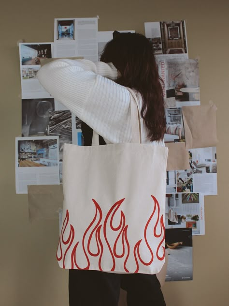 "Hand-painted \"flame\" design tote bag. A perfect accessory to spice up an everyday outfit. DETAILS: 16\" H x 15\" W x 21\" Handle and 3\" Gusset Like this item? Check out our website: https://www.dzaehelladreams.com/" Gift For Her Ideas, Tod Bag, Diy Bag Painting, Diy Tote Bag Design, Handpainted Tote, Painted Canvas Bags, Handpainted Tote Bags, Canvas Bag Diy, Shopping Market