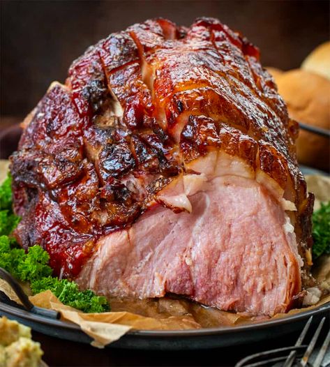 Brown Sugar Glazed Ham is a bone-in ham topped and roasted with a sweet, tangy, and spiced brown sugar glaze that creates a caramelized coating. It is so easy to make and perfect for your Christmas dinner menu! It is so delicious in all of your leftover ham recipes! Ham With Coke And Brown Sugar, Bone In Ham, Brown Sugar Glazed Ham, Ham Shank, Egg Bakes, Lunch Sandwiches, Brown Sugar Ham, Ham Glaze Brown Sugar, Ham Recipes Baked