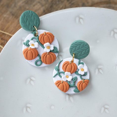 pumpkin vines polymer clay handcrafted Statement Earrings * Made with a polymer clay base. * Features nickel free findings. * Lightweight and comfortable for everyday wear. * Each piece is meticulously handcrafted. * Every earring is baked, sanded, drilled, and assembled by hand. * Colors may vary slightly due to lighting in photos. * Each pair is uniquely one-of-a-kind. Care Instructions * Avoid sleeping or swimming while wearing the earrings. * Keep them away from perfume or oils. * Do not ben Pumpkin Clay Earrings, Clay Pumpkin Earrings, Clay Earrings Halloween, Pumpkin Clay, Polymer Clay Recipe, Clay Pumpkin, Pumpkin Vine, Pumpkin Jewelry, Pumpkin Stands