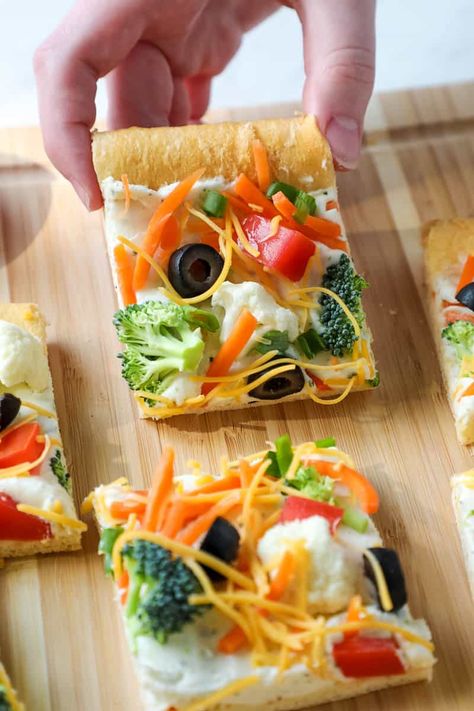 Veggie Pizza is an easy appetizer for potlucks, tailgate parties, showers, and picnics – using crescent rolls and your favorite veggies! Crescent Roll Veggie Pizza is a classic appetizer that’s a hit at every party! You know you’ve had it before—that crescent roll crust, a creamy topping, and fresh vegetables and cheddar cheese on top. (Don’t forget the black olives!) Cresent Roll Veggie Pizza Recipes, Veggie Bars Crescent Rolls, Cresent Roll Veggie Pizza, Veggie Bars Recipe, Simple Homemade Pizza, Using Crescent Rolls, Veggie Pizza Appetizer, Crescent Roll Veggie Pizza, Cold Veggie Pizza