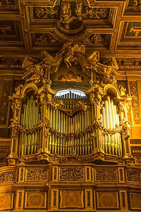 San Giuseppe dei Falegnami, Rome. The large wooden bow-fronted organ gallery, which is corbelled out and occupies the entire width of the nave. The actual organ case is a spectacularly intricate piece of Baroque design featuring carved angels blowing trumpets. Just above the pipes is a fresco of an angelic musical trio. Baroque Music, Pipe Organ, Sacred Architecture, Baroque Design, Wooden Bow, Trumpets, Rome, Musical, Carving