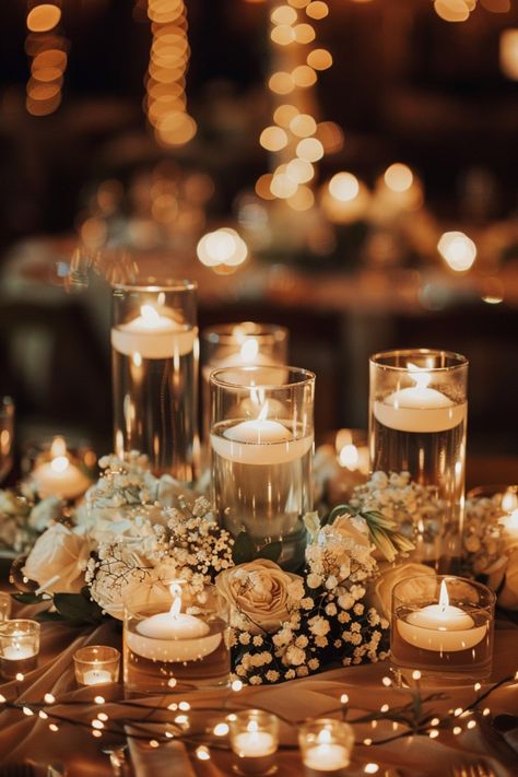 Create a romantic glow at your wedding with candle centerpieces. See more inspiration here. Candles In Jars Wedding, Simple Romantic Wedding Table Decor, Gold Candle Wedding Centerpieces, Wedding Centerpieces Romantic Elegant, Wedding Decor Candles And Flowers, Wedding With Candles And Lights, Wedding Greenery And Candles, Fairy Light Reception Decor, Fall Wedding Floating Candles