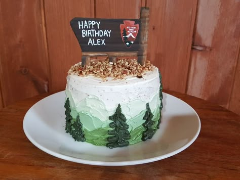 National Park Service wooden sign birthday cake with mountains and trees. Mountain Smash Cake, National Park Cake Ideas, National Parks Cake, Camp Smash Cake, Mountain 1st Birthday, Camping First Birthday Cake, National Park Cupcakes, National Park Birthday Cake, Camping Themed Birthday Cake