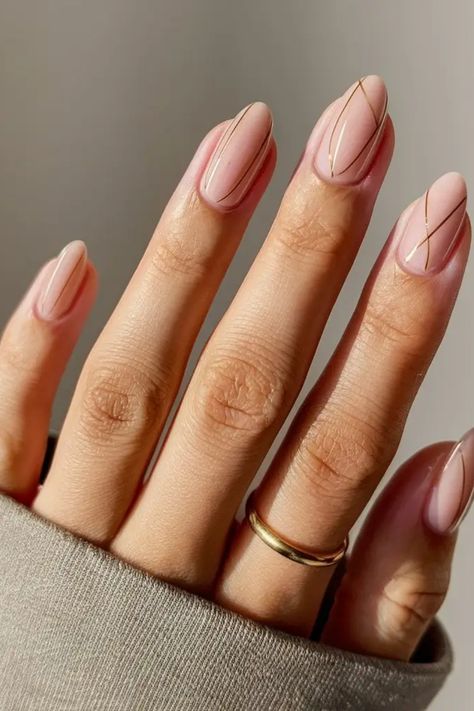 Hand with a gold ring displaying manicured nails with minimalist geometric nail art. Perfect Nails For Summer, Minimalist Vacation Nails, Nails Simplistic, Almond Nails Simple Design, Nail Minimal Design, Nude Design Nails, Line Work Nails, Nude Nails Design, Nail Lines