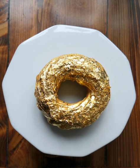 Executive chef Björn De La Cruz of Williamsburg’s Manila Social Club uses some of the finest ingredients, including Cristal Champagne jelly and icing and 24-karat gold dust, to create the Golden Cristal Ube Donut. They cost $100 a piece or $1,000 a dozen and must be pre-ordered. Champagne Jelly, Cristal Champagne, Filipino People, Gluten Free Doughnuts, Edible Gold Leaf, Types Of Desserts, Doughnut Cake, Edible Gold, Dessert Display