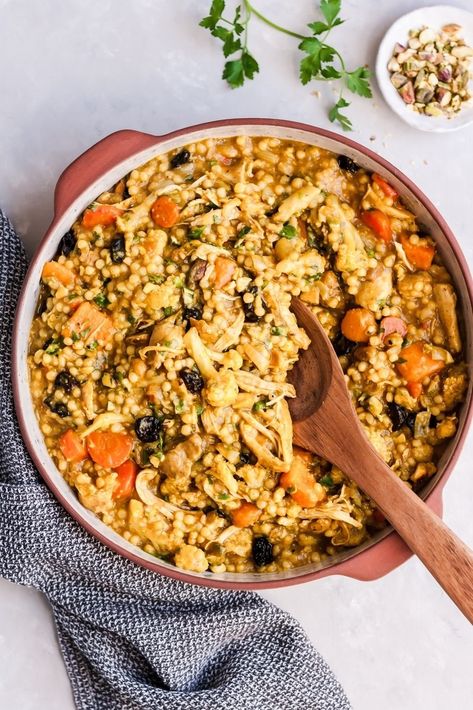 The most delicious Moroccan Chicken Stew with sweet potato, couscous and cauliflower. Simmered with cozy spices thanks to cinnamon, anti-inflammatory turmeric, and earthy cumin. Pistachios, dried cherries and parsley are stirred into this stew once done cooking for a unique twist. #moroccan #stew #chickendinner #healthyrecipe Moroccan Chicken And Couscous, Sweet Potato Couscous, Moroccan Cauliflower, Moroccan Chicken Stew, Mediterranean Sweet Potatoes, Slow Cooker Moroccan Chicken, Moroccan Stew, Chicken Couscous, Moroccan Couscous