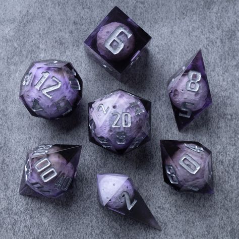 The full set will come with D4 D6 D8 D10 D% D12 D20. The asteroids are made out of resin, the same material as the clear portion of the dice, and remains balanced. For use with DnD, Pathfinder, and other TTRPG systems. Asteroid dice set comes in a custom-made velvet pouch and wooden box, providing convenient storage and portability. Take them with you to gaming sessions, conventions, or unleash them upon your gaming table, instantly transforming your gaming space into an enchanting realm of adve Dnd Aesthetic Dice, Dice Ideas, Cool Dnd Dice, Pretty Dice, Dice Goblin, Gaming Space, Dnd Dice Set, Dungeons And Dragons Dice, Gaming Table