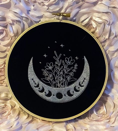 Finished Embroidery of a moon growing flowers. This piece is a gold thread on black cotton fabric and can be used to decorate any space. To neatly finish off the back felt is hand sewn onto the hoop. The product is handmade by myself and has an approximate diameter of 6 inches or 15.24 centimeters. Processing takes around 2-5 days. Thank you so much for your support! :) Full Hoop Embroidery, Embroidery Patterns On Black Fabric, Black On Black Embroidery, Monochrome Embroidery, Stars And Flowers, Moon Embroidery, Collection Ideas, Black Cotton Fabric, Embroidery Tshirt