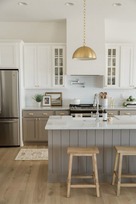 Gold Kitchen Pendants with Taupe Cabinets Wood Kitchen Grey Countertop, Kitchen With Light Brown Floors, White Kitchen Cabinets With Tan Island, White Cabinets Different Color Island, Beige Lower Cabinets White Upper, Beige Bottom Cabinets White Top, Kitchen Cabinet And Wall Color Combos, Tan And White Kitchen Cabinets, Light Brown Kitchen Floors