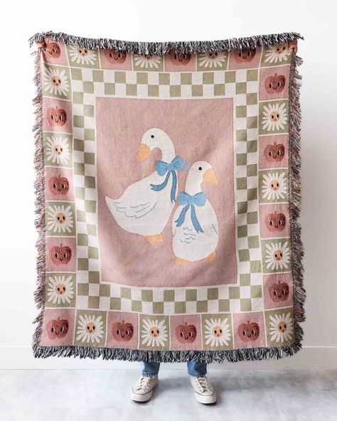 The Silly Goose Blanket is a charming, sweet, and fun way to stay cozy. A light pink background is the backdrop for a playful retro design, showcasing cute silly geese and a checker border (including cheerfully smiling apples and flowers). Woven from 100% cotton threads, not printed, it offers beautiful texture and depth of color. The nostalgic retro pattern is light-hearted and comforting, ideal for young ones and adults alike. Bring this delightful blanket into your home, or send it as a sweet Pastel Farmhouse, Country Cottagecore, Cute Goose, Maximalist Eclectic, Checkered Decor, Nursery Room Inspiration, Silly Goose, Cotton Throw Blanket, Nursery Inspo