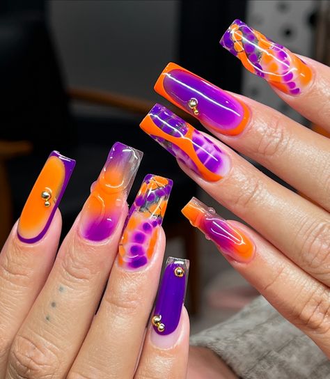 The perfect duo 🧡🫶🏼💜 . . . . . . . . . . . . . #nailinspo #orangenails #purplenails #mixmatchnails #gelx #gelxnails #bostonnails #bostonnailtech Orange And Purple Nails Ideas, Orange And Purple Nail Designs, Purple And Orange Nails Acrylic, Purple And Orange Nail Designs, Orange Purple Nails, Purple Orange Black Nails, Orange And Purple Nails, Purple And Orange Nails, Mix Match Nails