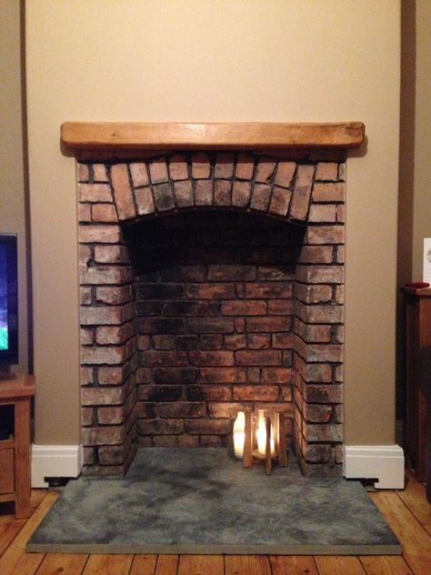 Beautiful original fireplace I discovered in my 1935 property. Love the brick arch. Arch Brick Fireplace, Brick Arch Fireplace, Arched Brick Fireplace, Fireplace Arch, Brick Fireplace Log Burner, Brick Fireplace Mantles, Corner Fireplace Makeover, Brick Chimney Breast, Arched Fireplace