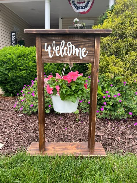 Wooden Welcome Plant Hanger, Wreath Stand Front Porches, Outdoor Welcome Plant Stand, Garden Decor Projects, Garden Wallpaper, Basket Planters, Front Porch Decorating, Hanging Plant, Plant Stands