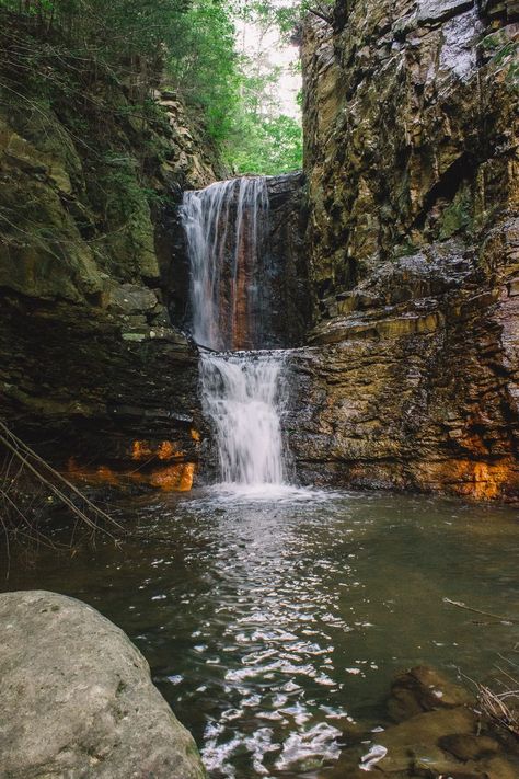 A waterfall makes its way between two rock walls, carving out a wide path for the water to take. Two levels of falling water, orange and brown rocks everywhere. A beautiful peaceful landscape photo. Falls Creek Falls Tennessee, Copperhill Tennessee, Tennessee Aesthetic Country, Tennessee Mountains Aesthetic, Cades Cove Tennessee Photography, Tennessee Countryside, Tennessee Waterfalls, Mountains Aesthetic, Fall Break