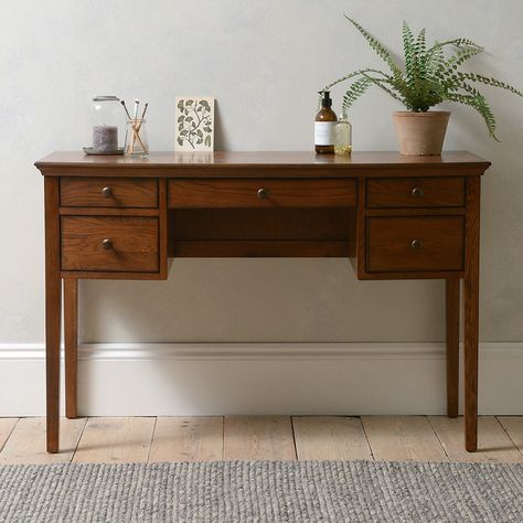 A slim and elegant design, our dressing table offers a practical spot for getting ready. With an array of different-sized drawers for keeping everything tidy and organised, the matching mirror and stool completes the set. Winchcombe Dark Oak Inspired by a chance encounter with a charming piece of French antique furniture, Winchcombe Oak is a timeless and thoughtfully designed range with a rich and distinctive finish. Warm and characterful with a beautiful natural grain running through it, it's a Dark Oak Desk, New Dressing Table, Dark Oak Furniture, Small Dressing Table, Dresser Kitchen Island, Dressing Table With Drawers, Furniture Dressing Table, Home Office Furniture Sets, Kitchen Island Table