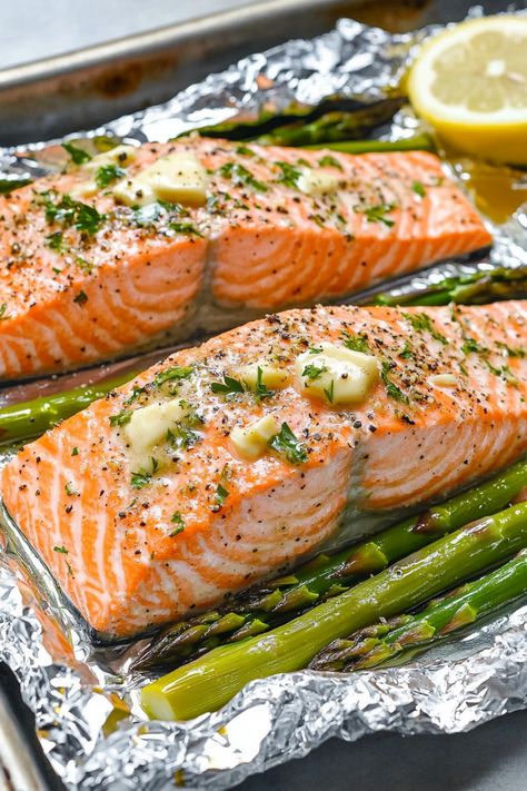 Discover the perfect weeknight dinner idea with this easy recipe for baked salmon and asparagus in foil. This dish is not only delicious but also quick to prepare, making it ideal for busy evenings when you want a healthy meal without all the fuss. The combination of tender salmon, flavorful asparagus, and zesty seasonings all cooked together in a foil packet creates a mouthwatering meal that will impress your family and friends. Salmon With Asparagus In Foil, Salmon Foil Packets Oven Asparagus, Oven Baked Salmon And Asparagus, Baked Salmon In Foil With Asparagus, Foil Packet Salmon Oven, Salmon Foil Packets Oven, Salmon And Asparagus In Foil, Asparagus Pasta Recipes, Best Salmon Recipes