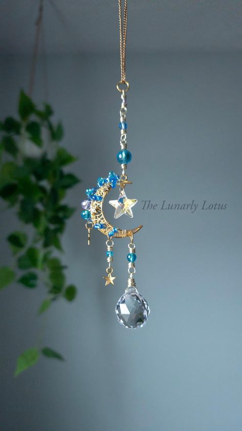 This enchanting charm showcases a luminous gold-colored moon charm adorned with delicate aqua and lavender beads, adding a touch of elegance and charm. The centerpiece of this remarkable piece is a mesmerizing 14mm AB glass star that catches the light beautifully, creating a shimmering effect that is truly mesmerizing. Adding to its allure, an exquisite Asfour crystal adorns the bottom of the charm, reflecting light and adding a sophisticated touch. This enchanting car charm is a perfect way to add a touch of celestial beauty to your vehicle, making it a stylish and eye-catching accessory that is sure to turn heads wherever you go.   The moon is a symbol of illumination, reflection, insight and guidance. ＊**̩̩͙✩*̩̩͙*˚ The Star is a symbol of hope and guidance, positivity, happiness and ren