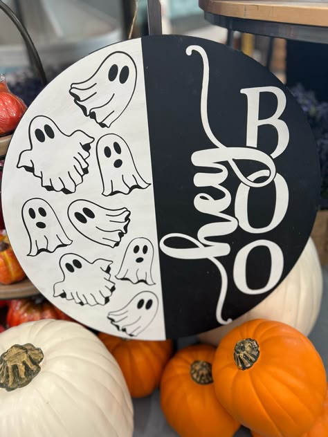 Looking for a fun and easy Halloween craft project? Look no further! Our Hey Boo With Ghosts Round Door Hanger DIY Craft Kit comes in your choice of 10" or 18" sizes. Perfect for painting and decorating in our studio in Fernandina Beach. Get spooky and creative with this Halloween Door Hanger. Painted Wood Pumpkin Sign, Hey Boo Door Sign, Spooky Door Sign, Diy Wood Round Sign, Round Wooden Halloween Signs, Easy Fall Cricut Projects, Front Door Decor Halloween, Spooky Crafts To Sell, Wooden Circle Crafts Diy