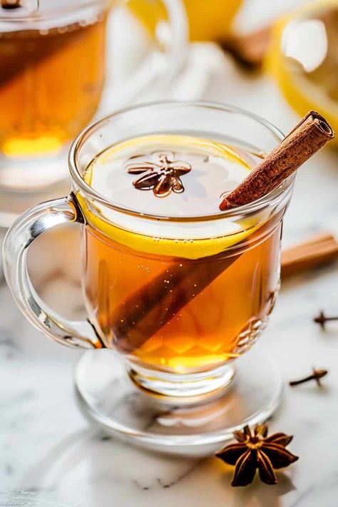 A clear glass mug of crockpot mulled cider, garnished with a lemon slice, a cinnamon stick, and star anise, with more spices scattered on a marble countertop in the background. Easy Apple Cider Recipe, Crockpot Drinks, Mulled Cider Recipe, Cozy Fall Drinks, Thanksgiving Crockpot Recipes, Green Bean Casserole Crock Pot, Cider Tasting, Peach Margarita, Apple Cider Recipe