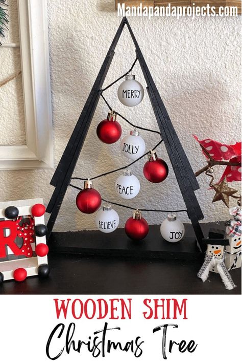 You’ll be Rockin’ around the Wooden Shim Christmas Tree this year after making this gorgeous black, red, and white themed DIY Christmas decor. This A-frame tree uses miniature Rae Dunn inspired ornaments for a sleek and classic look that’s a must add to your ‘Christmas crafts to make’ list this year! #diychristmasdecor Diy Wood Shim Christmas Trees, Wood Shim Christmas Trees, Shim Tree Ideas, Trees Made From Shims, Christmas Tree Made Out Of Shims, Wood Shim Trees, Shims Projects Ideas, Shim Christmas Trees, Shim Trees Diy