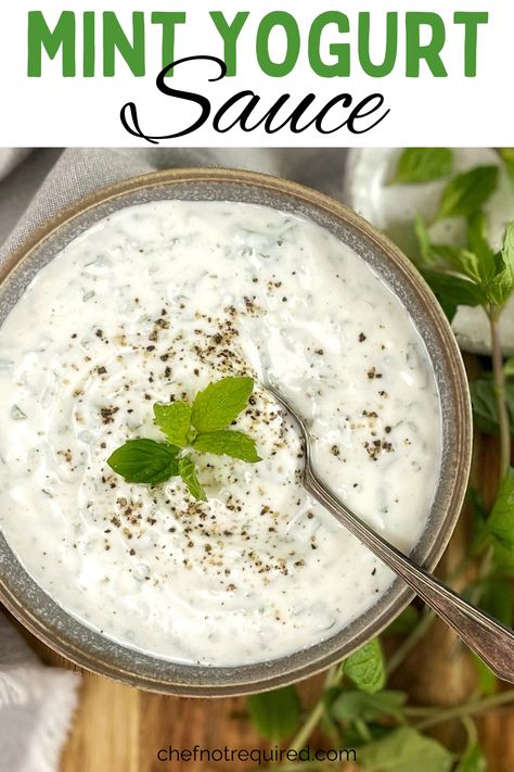 Creamy yogurt sauce in a gray bowl with mint and a spoon on a wooden board. Mint Yogurt Sauce Indian, Mint Yogurt Sauce For Lamb, Yogurt Sauce For Lamb, Spicy Yogurt Sauce, Yogurt Sauce Recipe, Lemon Greek Yogurt, Mint Yogurt Sauce, Creamy Dipping Sauce, Yogurt Dipping Sauce