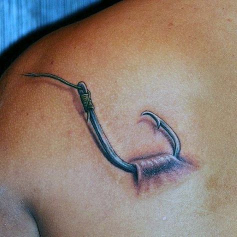 Man With Back Tattoo Of Fish Hook Catching On Skin Hook Tattoos For Men, Men Fish Tattoo, Small Fishing Hook Tattoo, Fish Hook Tattoo For Men, Tattoo Ideas For Men Fishing, Man Fishing Tattoo, Men Tattoo Ideas Fishing, Fisherman Tattoo, Fly Fishing Tattoo