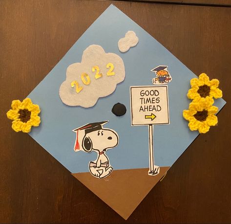 Graduation cap with snoopy walking towards a sign that says “good times ahead” with Woodstock. Felt cloud at the top reads 2022, and there are crochet sunflowers on the left and right corners of the cap. Charlie Brown Graduation Cap, Minimal Grad Cap Design, To Infinity And Beyond Graduation Cap, Garfield Graduation Cap, Gudetama Graduation Cap, Miffy Graduation Cap, Peanuts Graduation Cap, Snoopy Graduation Cap Designs, Minion Graduation Cap